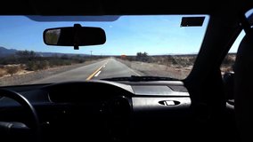 Back seat car point of view friends driving at outdoor highway, la rioja province, argentina