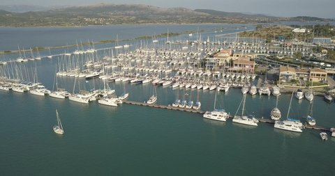 Aerial top view of boats and yachts in marina from above. Yacht parking, A marina lot, Yacht and sailboat is moored at the quay, Aerial view by drone. Lefkada island
