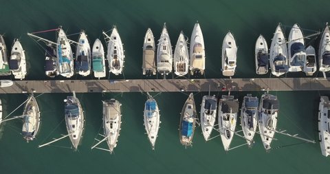 Aerial top view of boats and yachts in marina from above. Yacht parking, A marina lot, Yacht and sailboat is moored at the quay, Aerial view by drone. Lefkada island