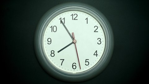
Slow motion clock isolated on black background, Showtime 07.54 am or pm, Red second hand minute Walk, Time concept.