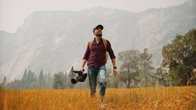 Filmmaker with professional camera in Yosemite National Park / Videographer, DP, Cinematographer   - Powered by Shutterstock - Get 15% off with code: PIKWIZARD15