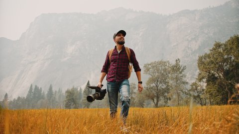 Filmmaker with professional camera in Yosemite National Park / Videographer, DP, Cinematographer  
