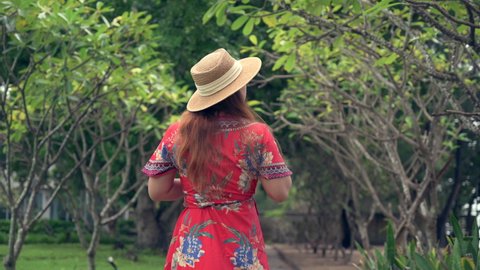 the woman walking in the park, the concept of travel, happy, relaxation and nature 