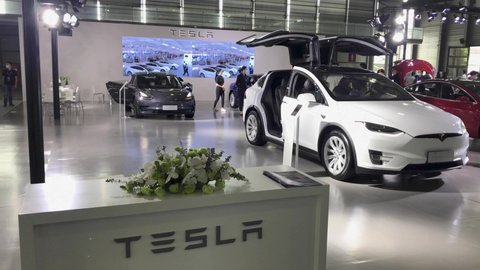 Shanghai, China - Sep 30, 2020: Tesla booth showroom in Shanghai Pudong International Auto Show. Car exhibition and vehicle promotion. Auto business and economy staff with mask coronavirus period