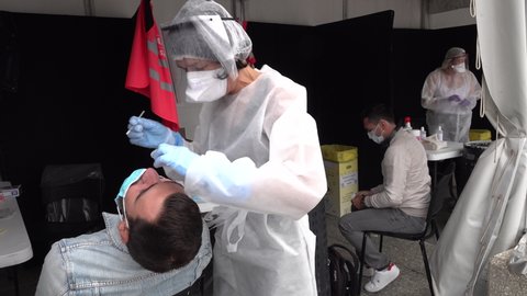 PARIS, FRANCE – SEPTEMBER 2020: Nurses with protective masks and face shields test potential Covid-19 patients in outdoor coronavirus testing center in Paris, health care and medical facility France
