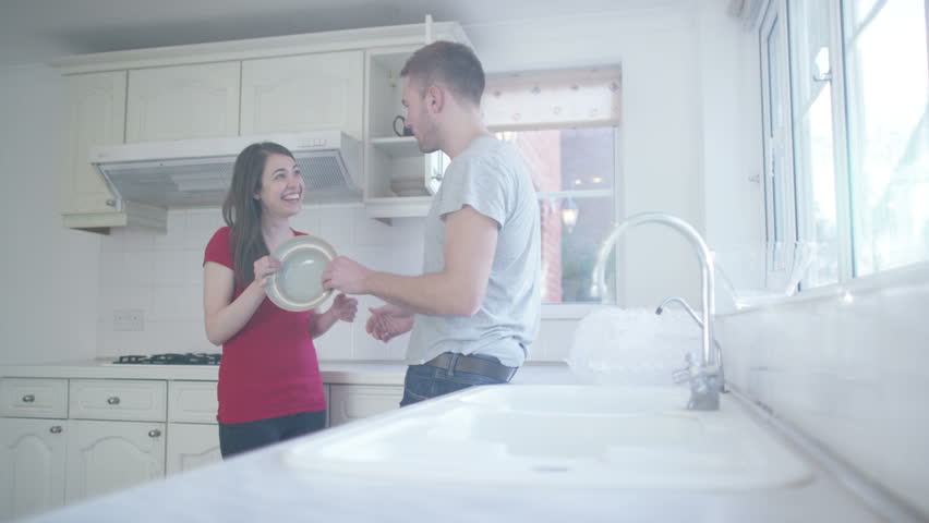 4K Happy young couple packing dishes away in the kitchen of their new home | Shutterstock HD Video #10608062