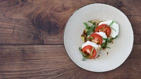 Serving a Caprese Salad on a Wooden Table	
