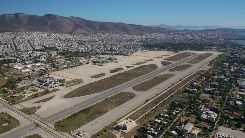 Aerial drone video of abandoned runway in former international airport of Athens in Elliniko area, South Athens riviera, Attica, Greece