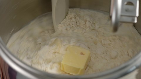 Machine knead bread dough. Raw dough in a industrial bakery dough mixer, food concept. Stock footage.close-up