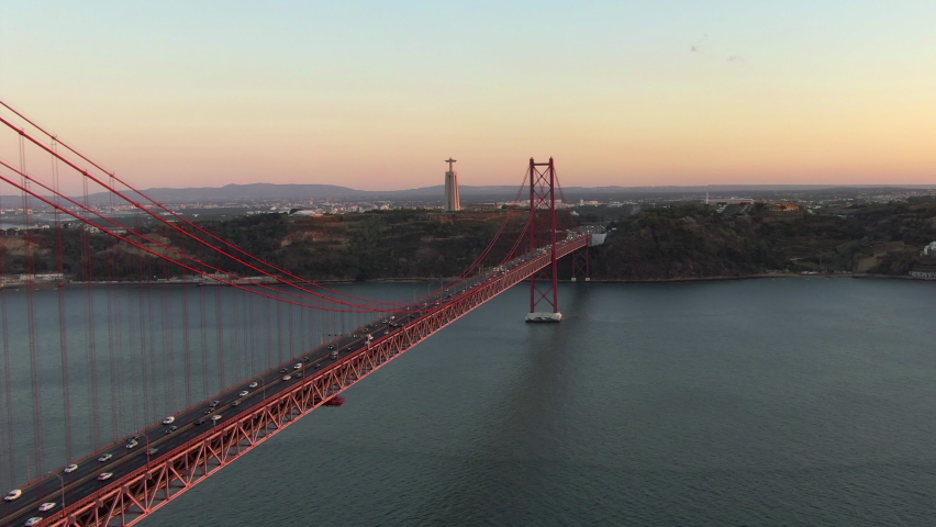 Aerial view of 25 de Abril bridge over the Tagus River at sunset in Lisbon, Portugal. 