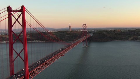 Aerial view of 25 de Abril bridge over the Tagus River at sunset in Lisbon, Portugal. 
