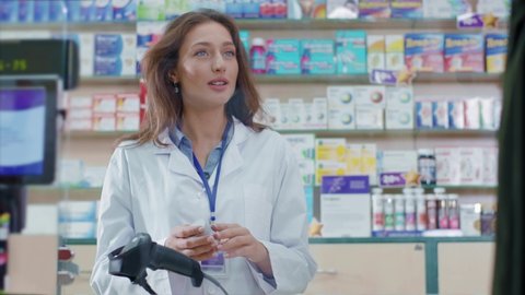 Pretty young female pharmacist consultant consulting male patient and giving medication sharing recommendations in drugstore. Healthcare, medicine.