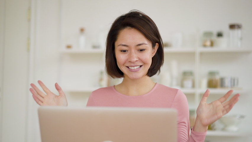 Smiling asian business woman using video conference call on laptop talk by webcam in online chat, mixed race female doing distant chat working from home, online conference during coronavirus covid 19