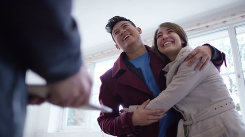 4K Young couple with real estate agent, looking at home to buy or rent