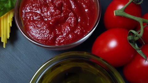 Ingredients for cooking tomato paste, ketchup, pasta. Italian cuisine: Tomato paste, spaghetti, tomatoes, olive oil, spices
