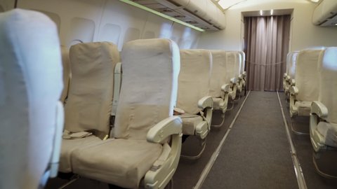 Interior inside airplane cabin without passenger. Empty plane seats.