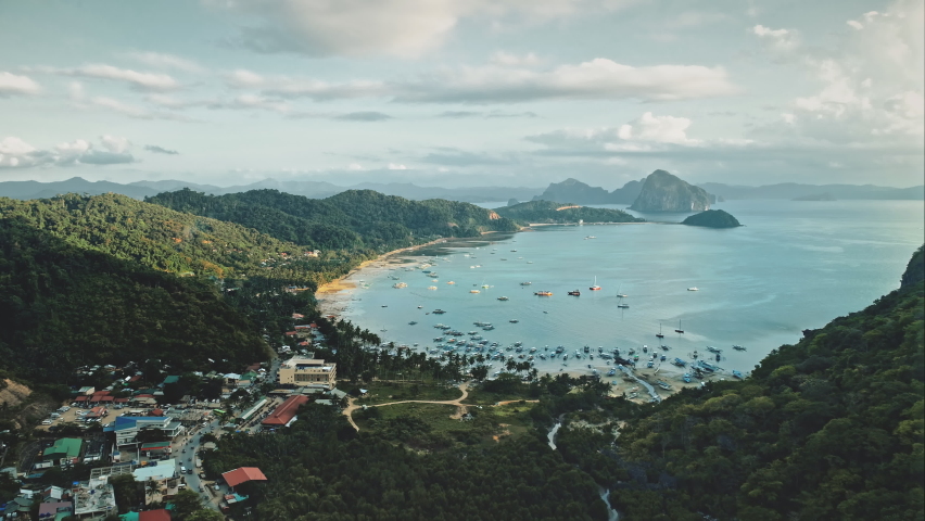 Port town cityscape at ocean gulf aerial view. Water transportation at sea bay harbour with ships, yachts, boats, vessels. Green mountain Philippines landscape with tropical forest at summer evening Royalty-Free Stock Footage #1060833847