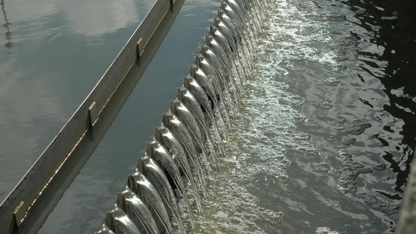 Sedimentation round tank  with rakes around. Detail of second step of sedimentation in modern city waste water treatment plant. Royalty-Free Stock Footage #1060839247