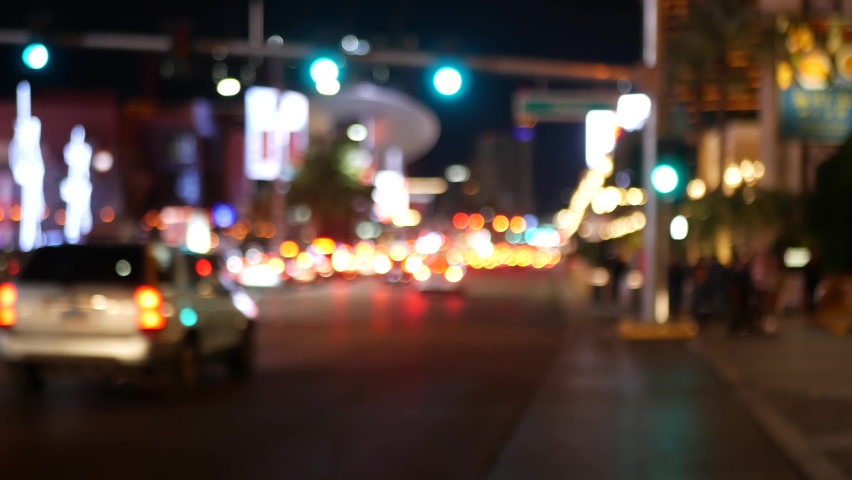 Defocused fabulous Las Vegas Strip boulevard, luxury casino and hotel, gambling area in Nevada, USA. Nightlife and traffic near Fremont street in tourist money playing resort. Neon lights of sin city.