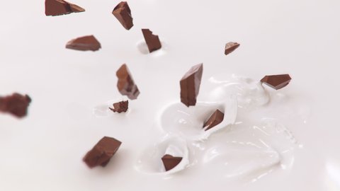 Pieces of Chocolate Falling Into Milk in 4K Super slow motion