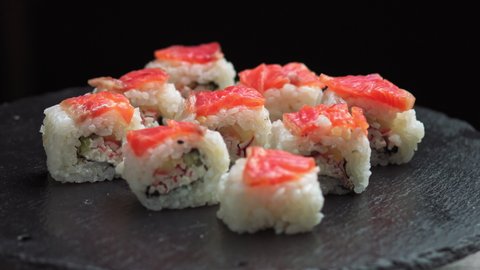 Sushi rotate.Macro set of fresh Philadelphia sushi from fish, salmon, rice, cucumbers. Sushi restaurant, sushi delivery. Selective focus