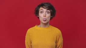 Smiling young woman 20s years old in yellow sweater posing looking camera chewing blowing bubble gum balloon inflates ball bursts it isolated on red wall background in studio. People lifestyle concept - Powered by Shutterstock - Get 15% off with code: PIKWIZARD15