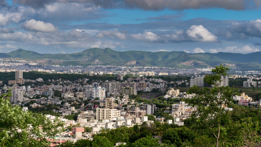 Cityscape View and 4k Time Lapse of Clouds Rolling over City Surrounded by High Hills and Mountains with Shadow of Clouds, Maharashtra, India Royalty-Free Stock Footage #1060853650