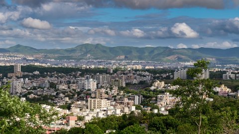 Cityscape View and 4k Time Lapse of Clouds Rolling over City Surrounded by High Hills and Mountains with Shadow of Clouds, Maharashtra, India