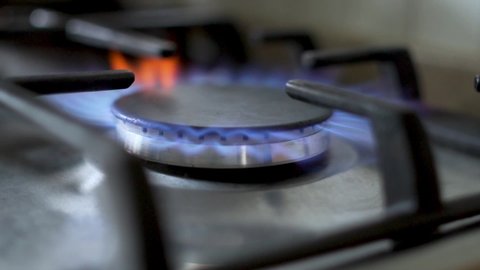 Flame Gas Burner Operation, Fire on the Stove. Gas Ignition. Gas is lit, Gas Burner on the Kitchen Stove, Close-up.
