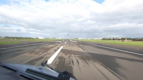 Pilot's view through the cockpit window during take off run - airplane taking off - acceleration until liftoff speed and climbing out