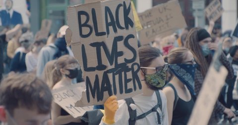 Bristol, UK - June 07 2020: Crowd of people marching with signs for Black Lives Matter