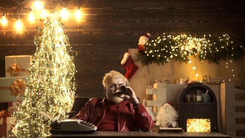 Drunken Santa at Christmas home. Sad alone man in Santas hat. Lonely friendless Christmas holidays concept. Older people loneliness, social problem. Unhappy depressive Santa closeup