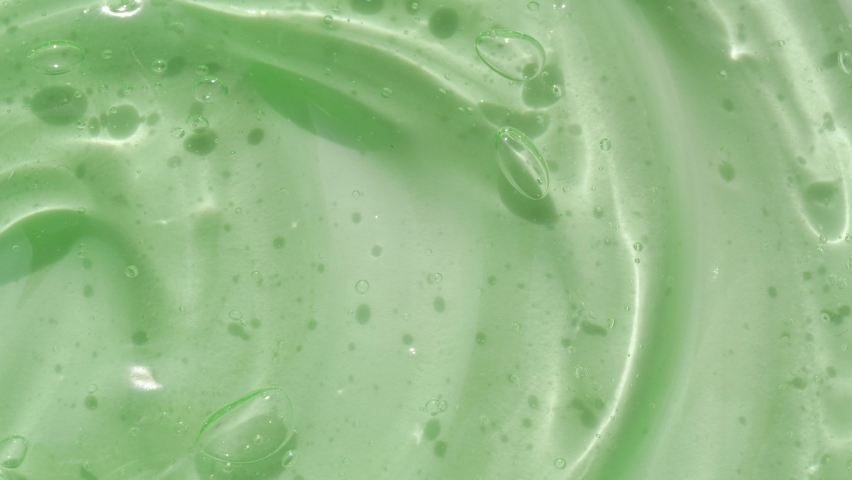 Aloe vera green serum beauty gel texture, hand sanitizer, macro anti ageing facial and eye skin care cream background | Shutterstock HD Video #1060864927