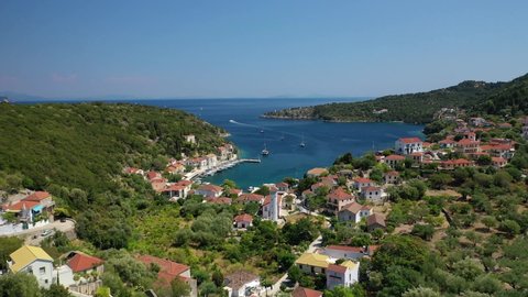 Aerial drone video of picturesque beautiful seaside village of Kioni a safe anchorage for yachts and sail boats, a true gem of Ithaki or Ithaca island, Ionian, Greece