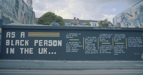Bristol, UK - June 07 2020: People walking past Black Lives Matter mural in Bristol