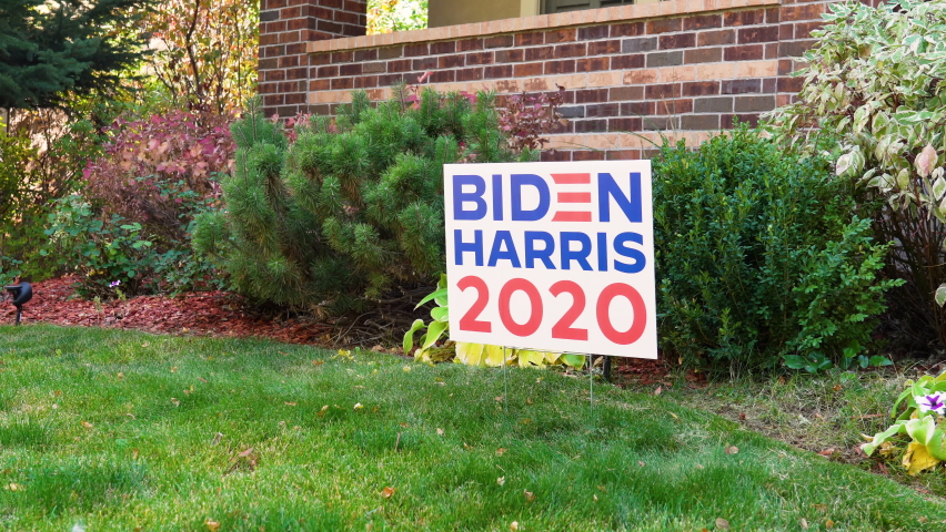 Young Man Removes Joe Biden Kamala Harris 2020 Yard Sign in Front Yard of House, Political Support