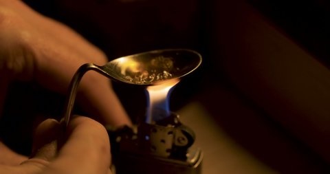 Cooking heroin in a spoon. Drug abuse and opiate addicts.