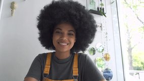 Young happy African American mixed race hipster vlogger woman waving hand looking at webcam talking to camera sit at table video conference calling in virtual chat meeting with social distance friend.