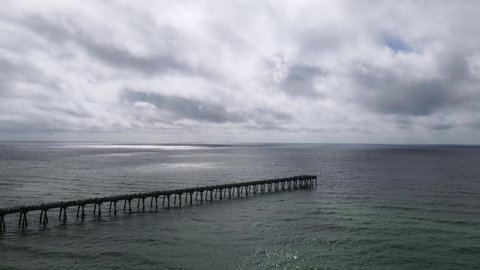 Calm Before the Storm Concept - Ocean Pier on Florida Coast Pre-Hurricane, Aerial Drone View