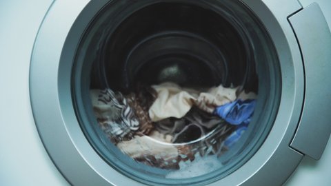 Laundry Machine Washing Disinfecting, Cleaning Clothes. Cylinder spinning.Things are spinning in drum of modern washing machine.