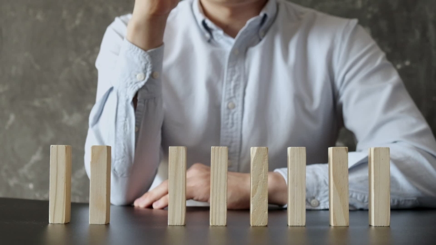Businessman Stop Domino Effect. Risk Management and Insurance Concept. | Shutterstock HD Video #1060900414