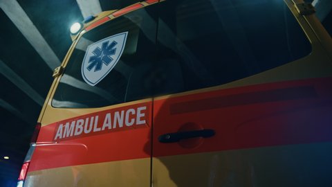 Team of EMS Paramedics Quickly Jump Out from Ambulance Vehicle. Female Doctor Takes First Aid Kit. Emergency Care Assistants Arrived on the Scene of a Traffic Accident on a Street at Night.