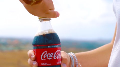 Florida / United States - 05 14 2019: Opening a cold plastic bottle of coca cola zero.