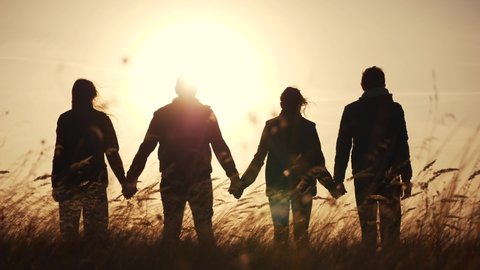teamwork. team community hold hands together silhouette at sunset unity. group of people hands. teamwork workers carry out put your hands up . team in the company working partnership business