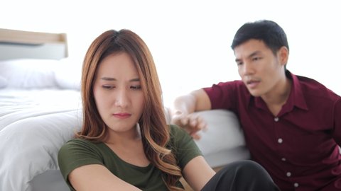 Asian couple have a fight in bedroom. Asian couple having difficulties in relationship. Wife always sulking. He has problem with erection too. Domestic violence concept.