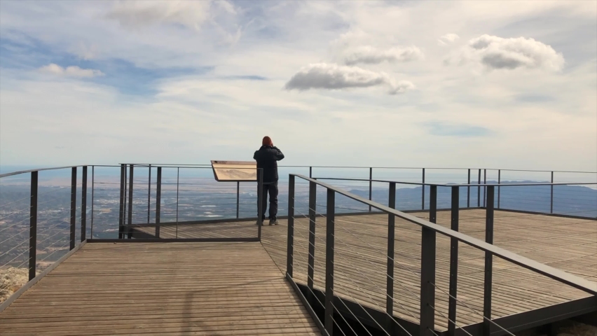 Tortosa, Spain, October 2020-Person looking through binoculars on top of the mountain | Shutterstock HD Video #1060916755