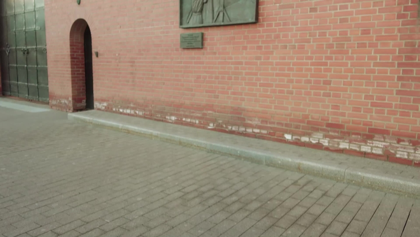 Teen girl photographed a plaque, which is dedicated to defenders of Moscow from the Nazi bombers. Moscow Kremlin, Russia.