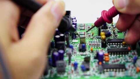 Electronics repair with tester.Repair technician test On an electronic board.Selective focus.