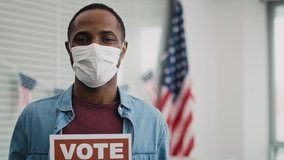 Video of black man in face mask with voting card. Shot with RED helium camera in 8K. - Powered by Shutterstock - Get 15% off with code: PIKWIZARD15