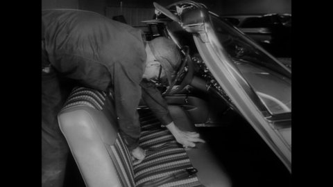 CIRCA 1961 - Seatbelts are installed in cars as a new safety feature.